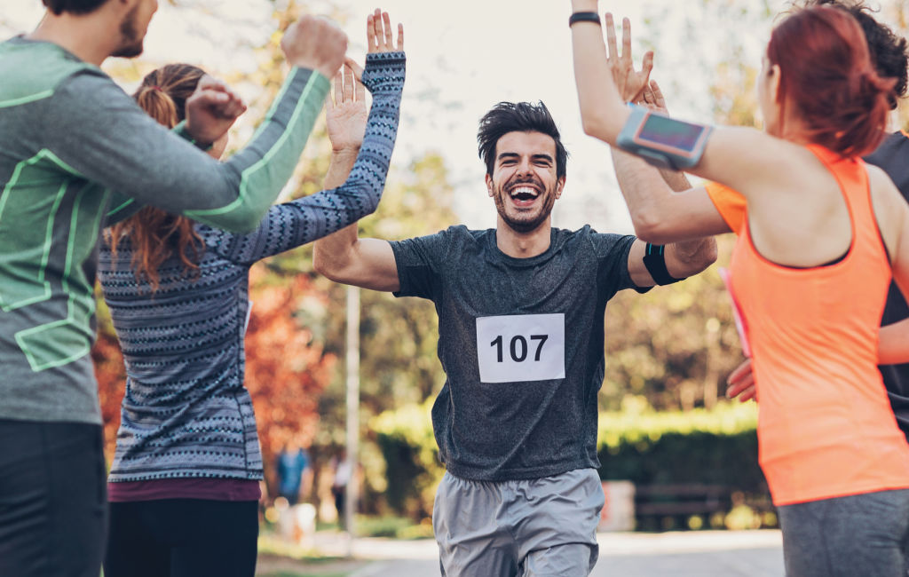 competitive runner giving high five