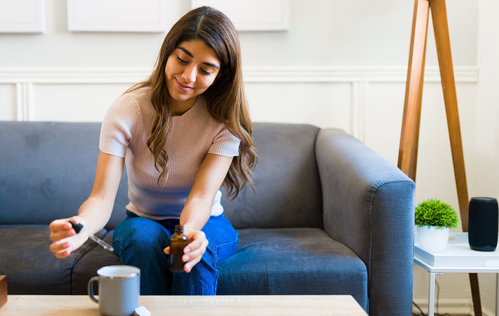 woman with CBD oil tea