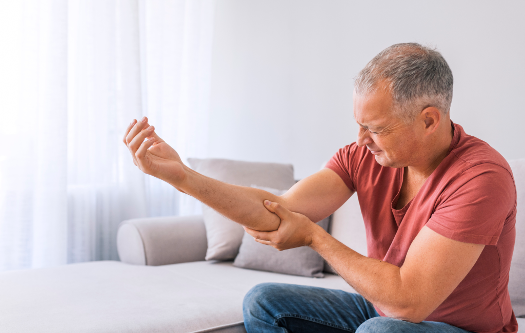 older man with elbow pain