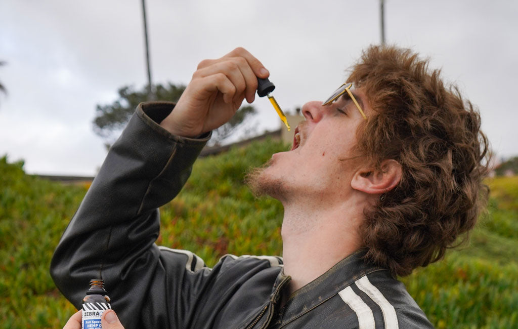 man using cbd oil