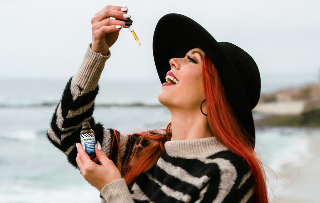Woman ingesting Zebra CBD oil