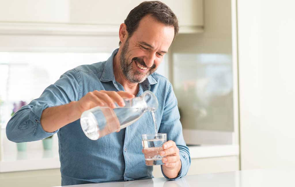 man pouring cbd water
