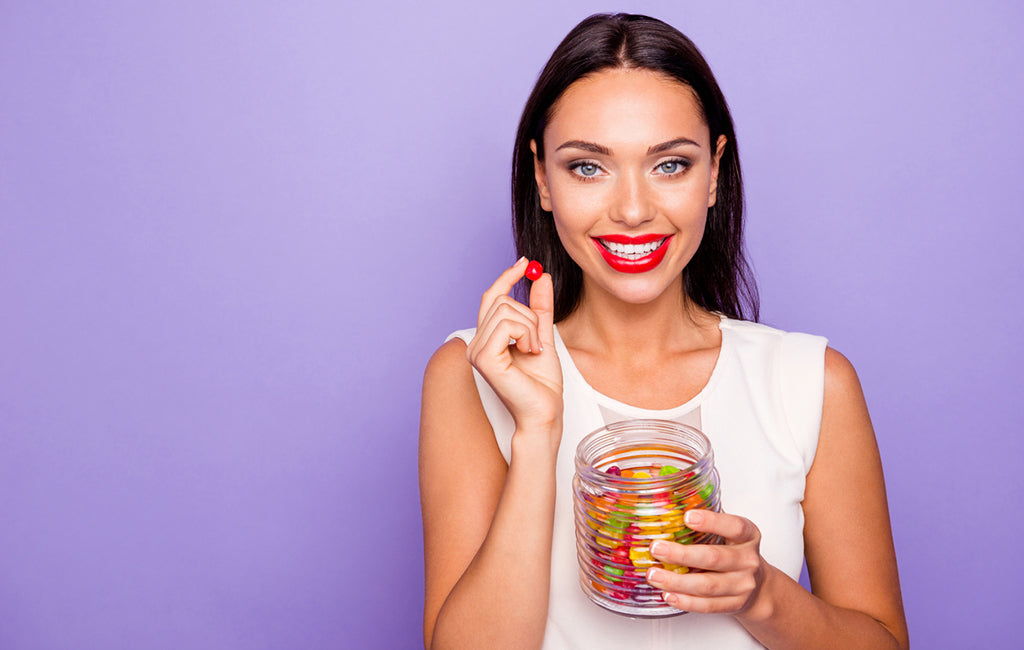 young woman eating CBD gummies