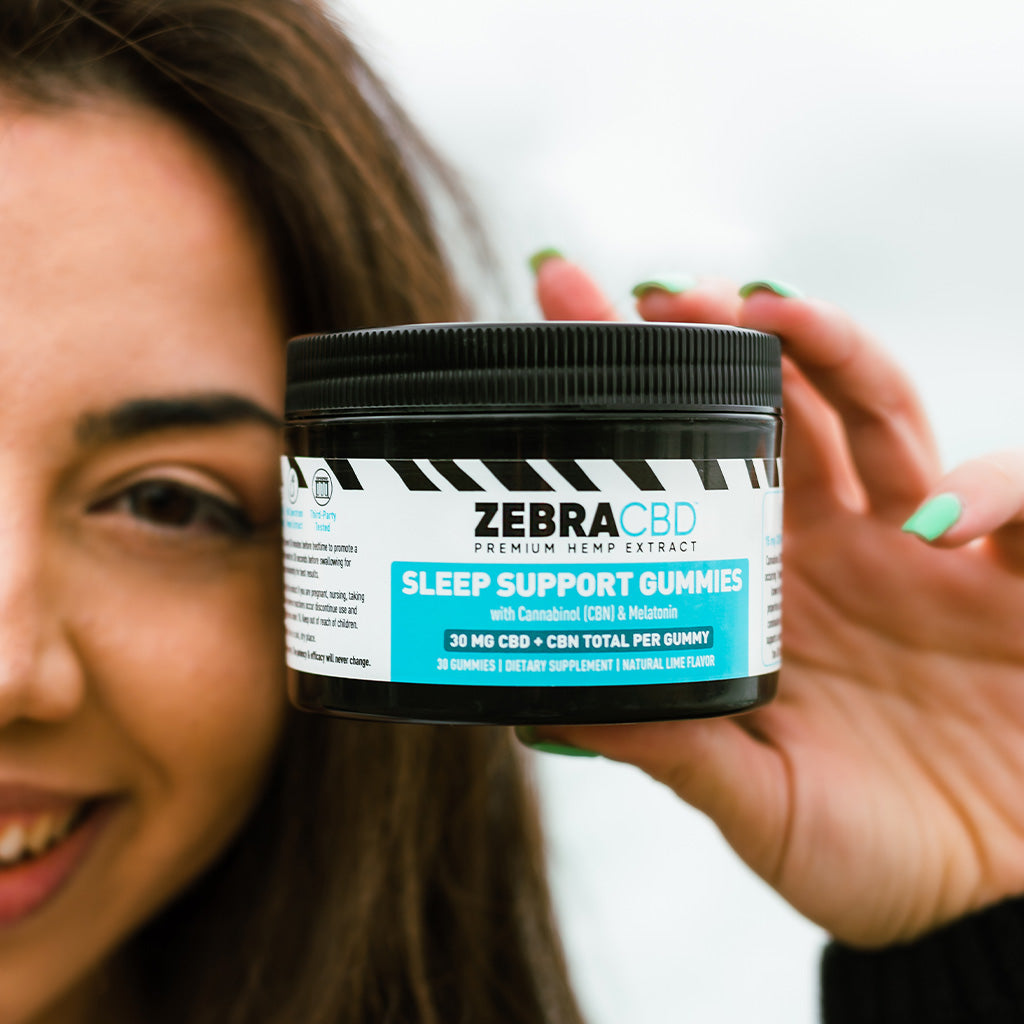 Customer holds CBD + CBN Sleep Gummies